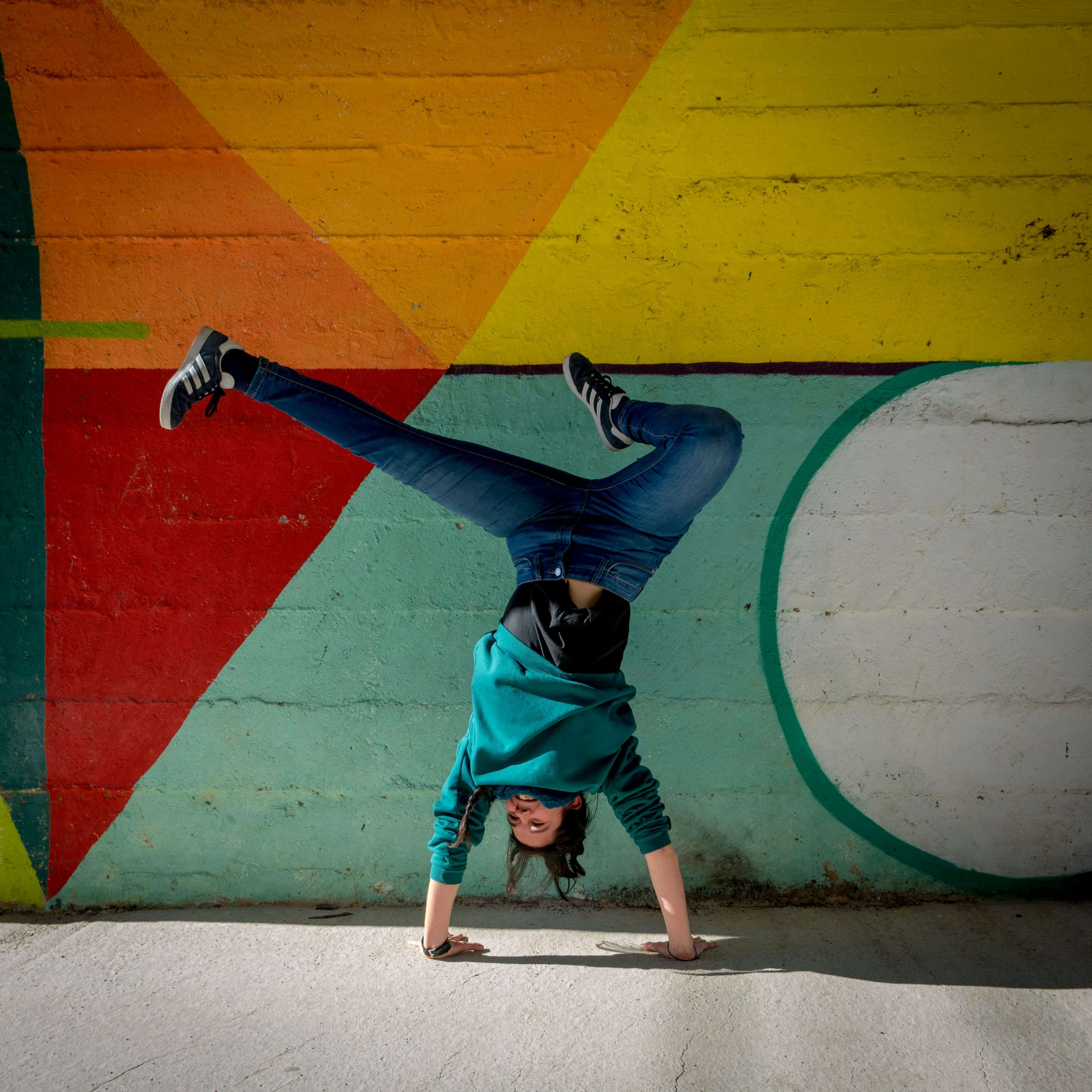 Girl Handstand behind artwall